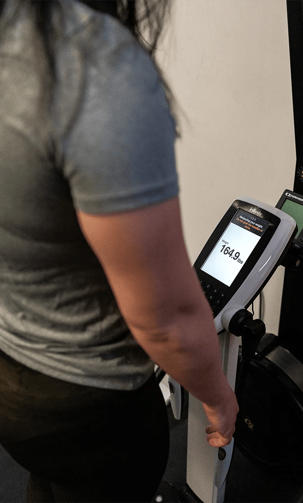 woman taking a body composition scan